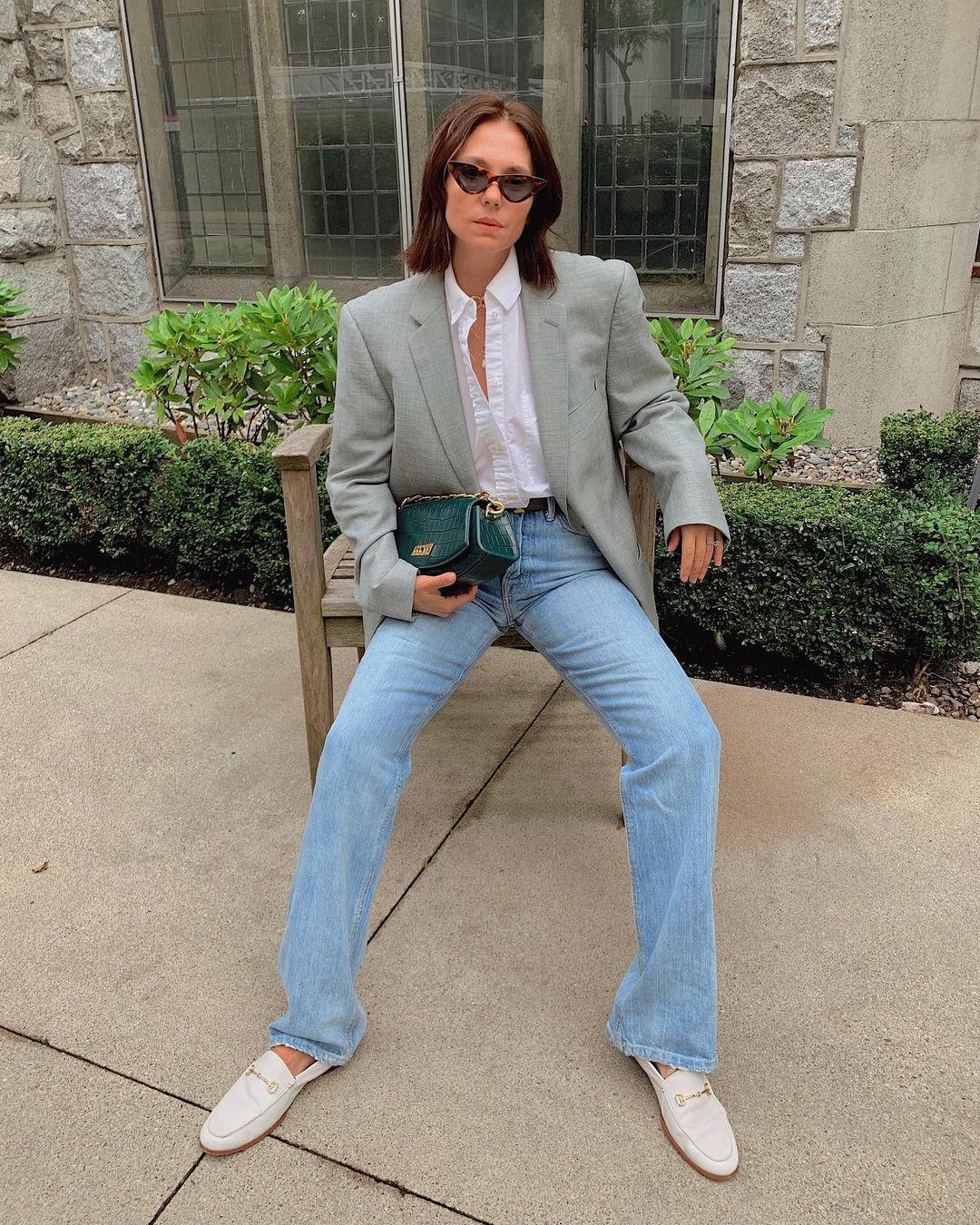 This Cool Outfit is One to Copy for Fall — @aurelafashionista in wide-leg jeans, flat white loafers, white button-down shirt, an oversized grey blazer, and cat-eye sunglasses