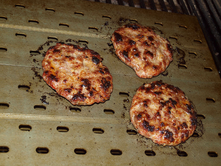 Pellet Smoker Cooking Italian Sausage Patties on Grill Grates