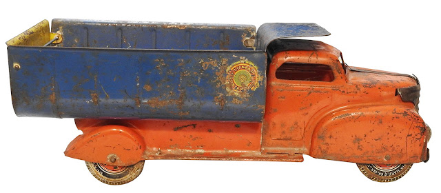 A vintage metal contractor's dump truck from Louis Marx, with metal tires.