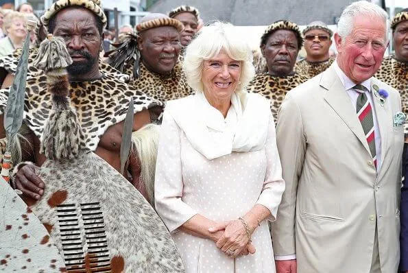 Prince Charles and Duchess of Cornwall met with King Goodwill and Queen Pumi of the Zulus. Burberry trench coat