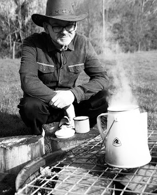 Cowboy looking lovingly at coffee
