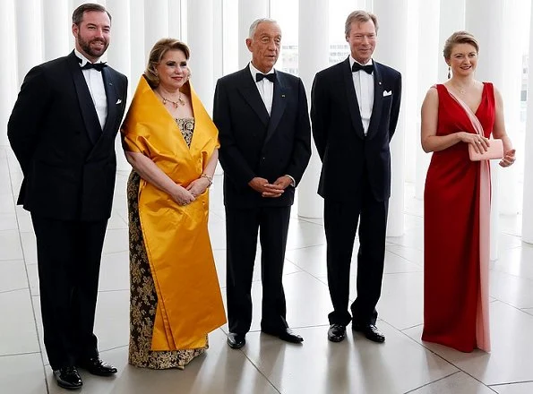 Princess Stephanie wore a red dress by French fashion house Paule Ka. Duchess Maria Teresa wore a dress by Belgian fashion designer Yves Dooms