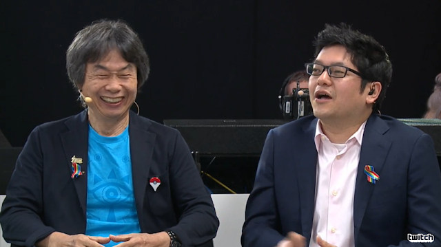 Shigeru Miyamoto Pokémon GO Plus rainbow ribbon Zelda pin laughs laughter eyes lines