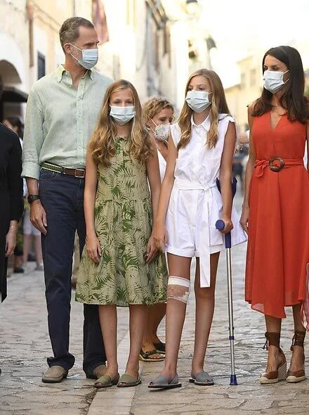 Queen Letizia wore a new textured midi dress from Adolfo Dominguez and leather wedges by Uterque. Princess Leonor and Infanta Sofia