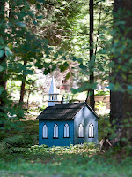 A smal blue-painted wood church at the edge of Marigold Springs; this is a miniature building