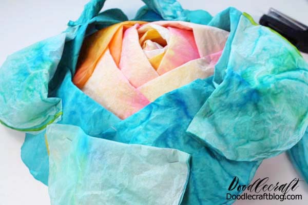 Stapled layers of bright colored coffee filters made into a fluffy layered rose.