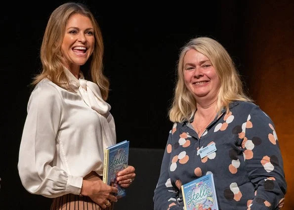 Princess Madeleine wore Dagmar Sabina pleated midi skirt. Princess at the launch of her book Stella and the Secret