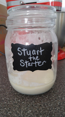 Wild Yeast Starter in a mason jar with the name, Stuart, written in chalk.
