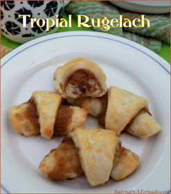 Tropical Rugelach is cream cheese based dough, topped with a sweet filling and rolled up crescent style. Featuring orange, pineapple and ginger this cookie makes you long for summer. | Recipe developed by www.BakingInATornado.com | #recipe #bake