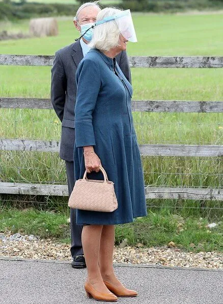 The Duchess of Cornwall wore a denim dress from Fiona Clare, and a neutral handbag and shoes. She wore her FitBit watch and some gold jewellery