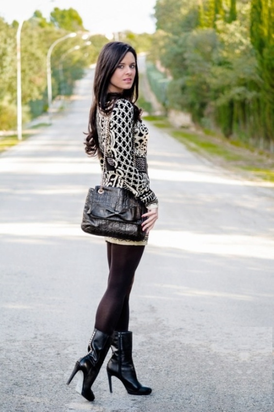 Lovely woman wearing a cute dress with black tights and boots