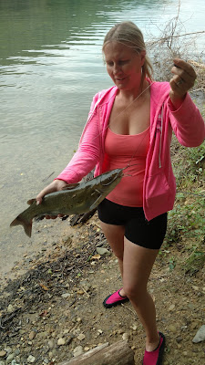 Blonde girl holding a catfish