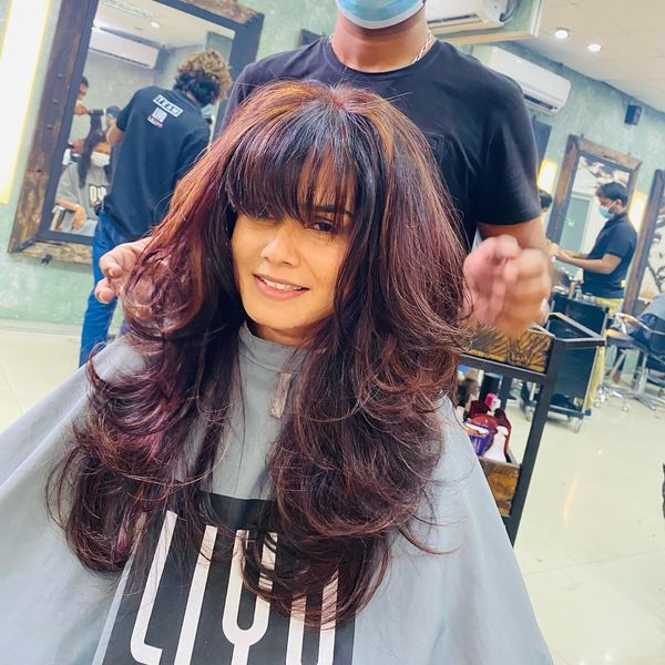 Village Barber Stories Front bangs with burgundy hair coloring Salon