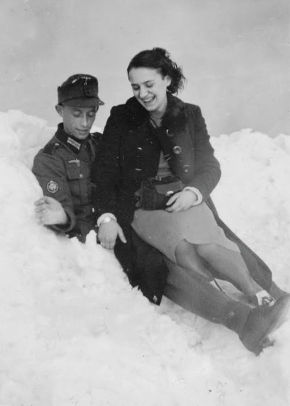 A friendly visit with a Wehrmacht Gebirgsjager (mountain) Troops private in a snowdrift. She appears to have nylons on, he apparently was quite thoughtful to get them for her - nylons were absolutely cutting edge style in the '40s.