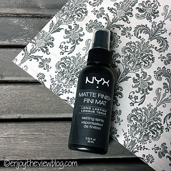 NYX Matte Finish Makeup Setting Spray on a black and white print background on a pallet