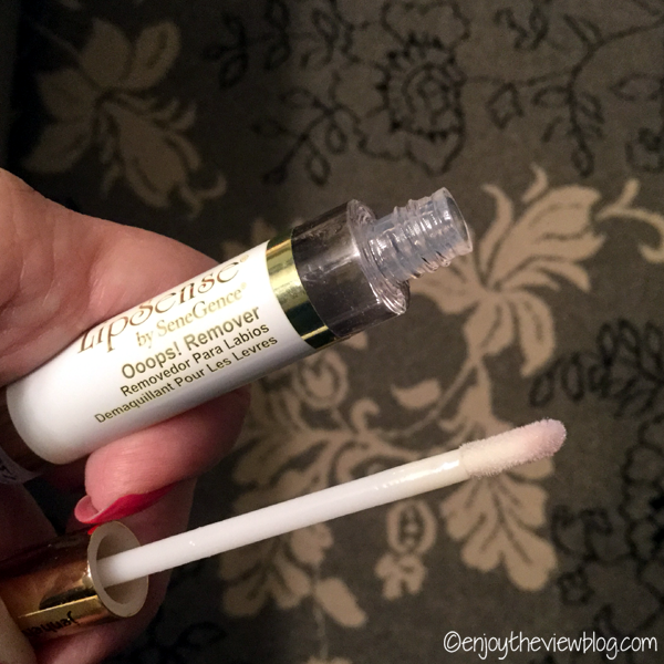 Tube of LipSense Ooops! Remover with applicator out of tube - being held in a hand