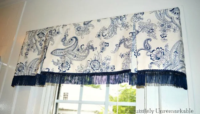 Blue and white Box Pleat Valance with blue fringe on bathroom window