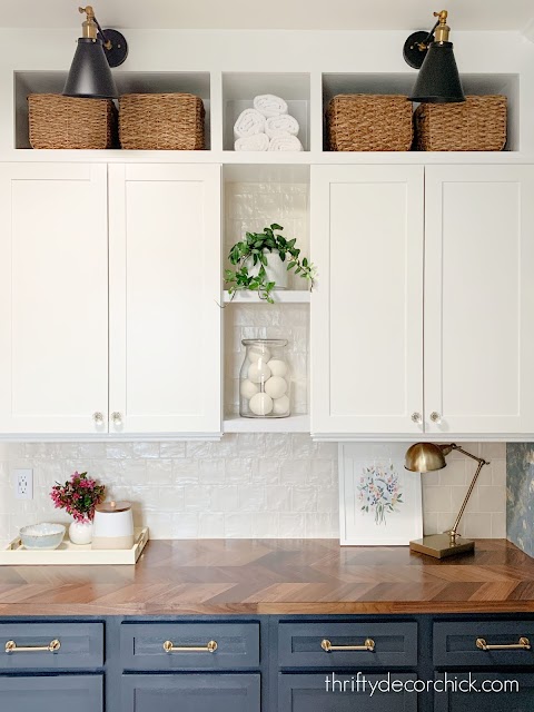 dark blue and white cabinets with brass hardware
