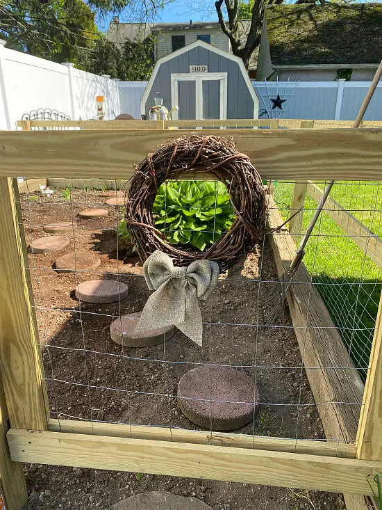 garden fence with grapevine wreath