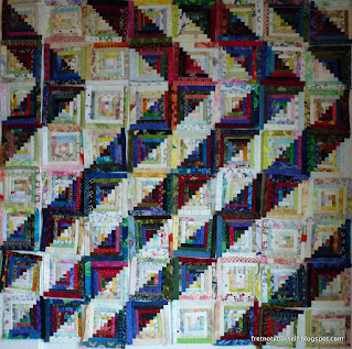 Multicolored scraps cut into half-inch logs make this quilt.