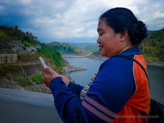 Woman Traveler Smiling Her Smartphone Above The Dam In The Cloudy Day Of Dry Season Titab Ularan North Bali Indonesia