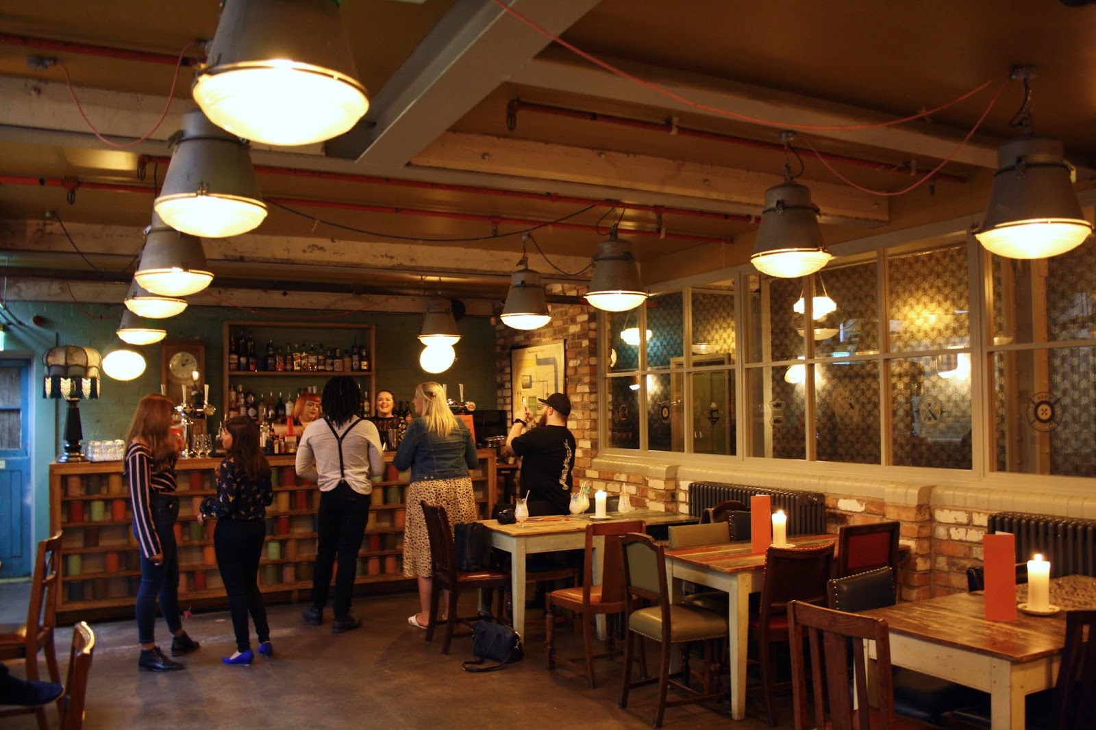 The interior of the Loom Room, including the bar which is decorated with spools of thread
