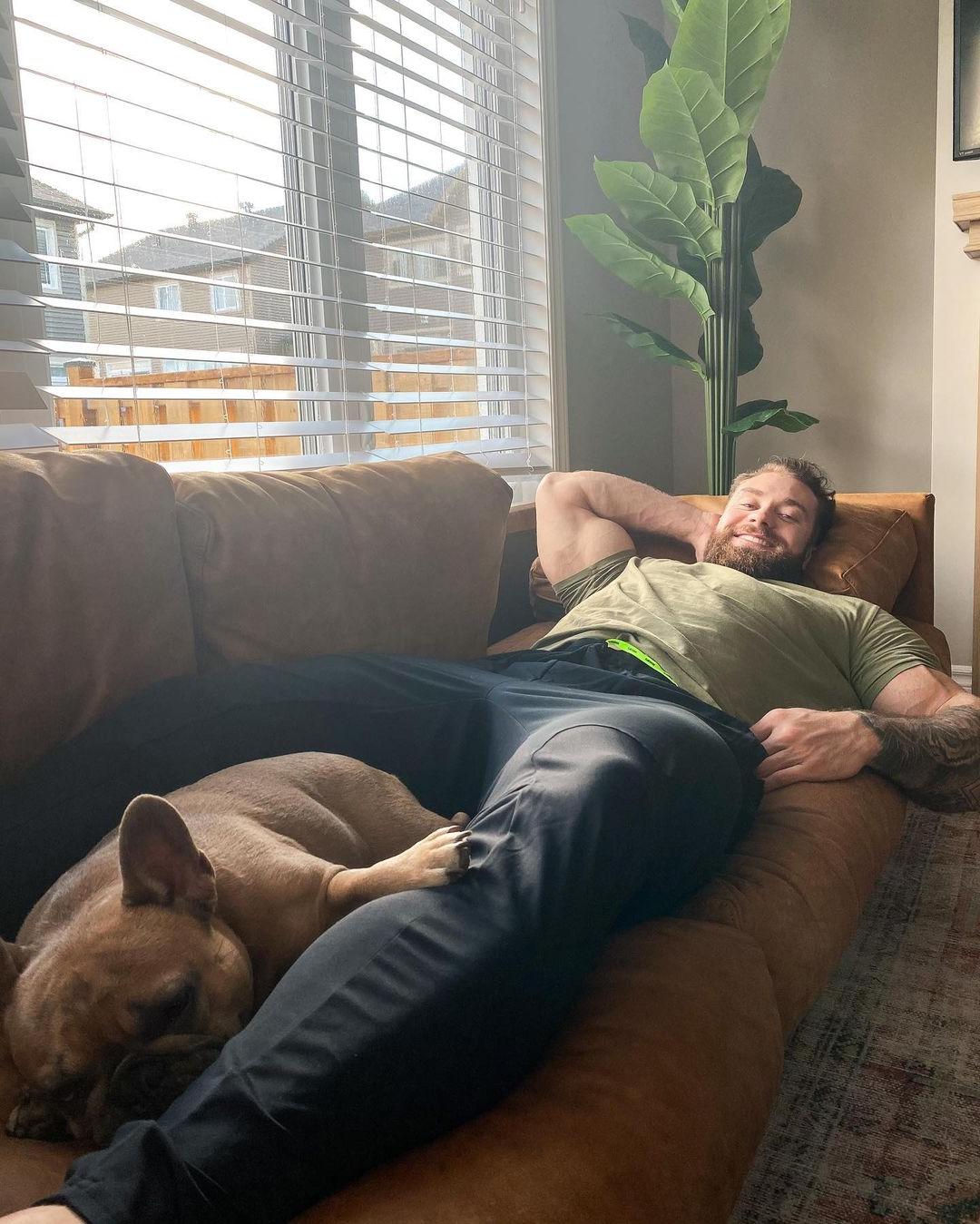 sexy-laid-back-daddy-bodybuilder-chris-bumstead-sleeping-dog-between-legs
