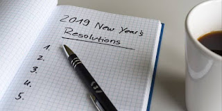 a notepad and a pen and a cup
