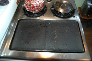 The blackened griddle covering the broiler of a vintage Chambers stove model B