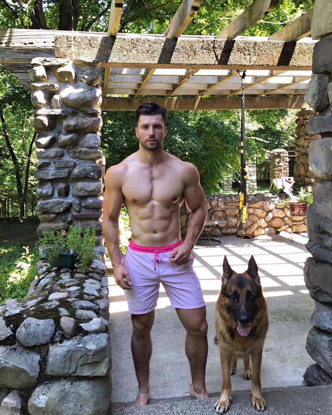 shirtless-wide-shoulders-muscle-daddy-kamil-nicalek-bodybuilder-dog