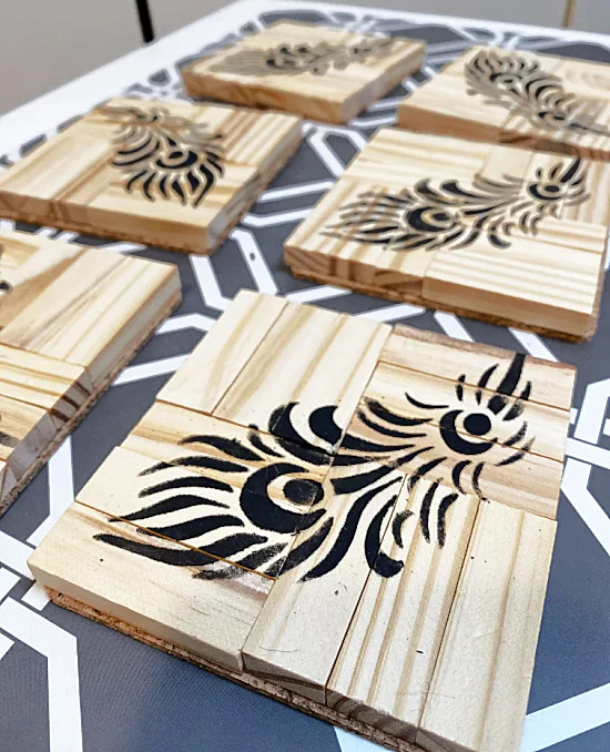 Black feathers on wooden coasters