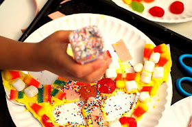 pouring on candy to create candy kids art