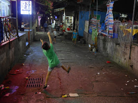 boy catches a paper ball at night in Zhuhai, China