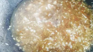 Simmering vegetables with corn starch water mixture for chicken manchow soup recipe