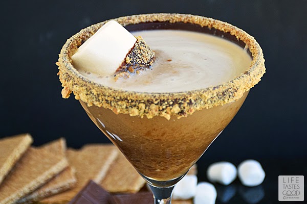 S'moretini | by Life Tastes Good is chocolate liquor, marshmallow infused vodka, and cream served in a martini glass rimmed with chocolate ganache and graham crackers! All of these wonderful flavors combine to make a drink that tastes like our favorite camping treat - s'mores! It makes a super fun party cocktail too!