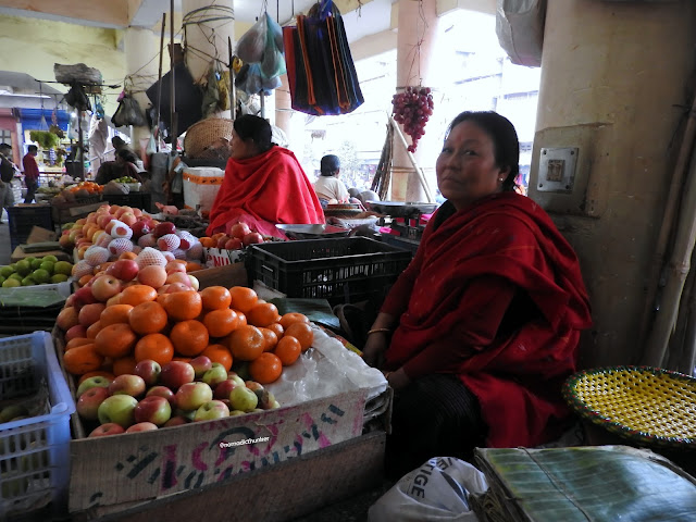 The ima who gave us an apple at Khwairamband Bazar | Manipur, India -- January 2017 Khwairamband Bazar , Imphal, Manipur, India, northeast, women, bazar, fruit, market, wholesale