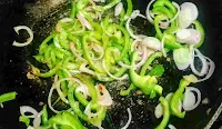 Stir frying onion and capsicum for chicken roll fillings