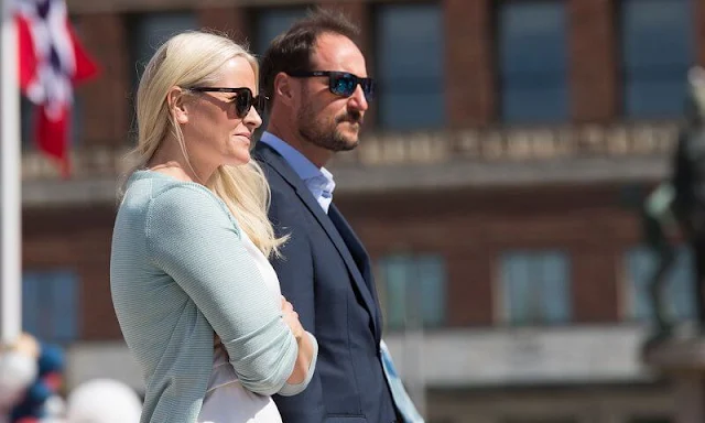 Crown Princess Mette-Marit wore nude eloise flats by Christian Louboutin. Maria La Rosa green clutch. Saint Laurent sunglasses