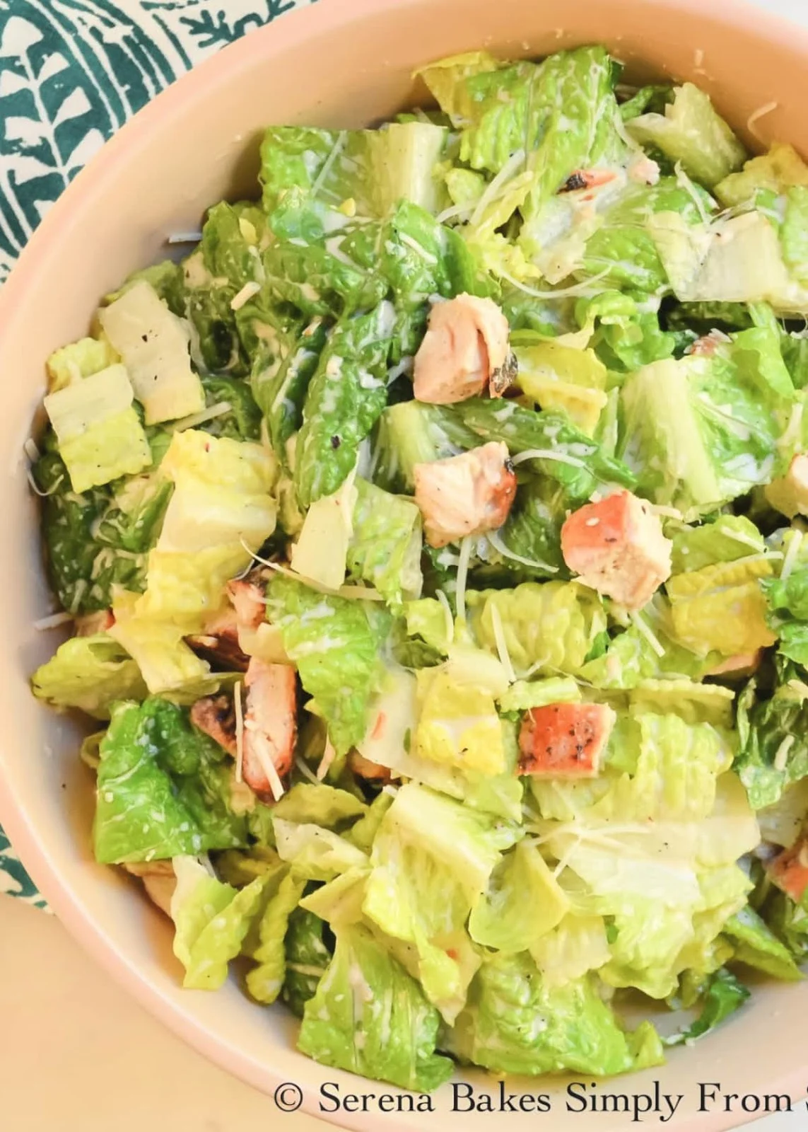 A large bowl of Chicken Caesar Salad tossed with Healthier Caesar Salad Dressing.