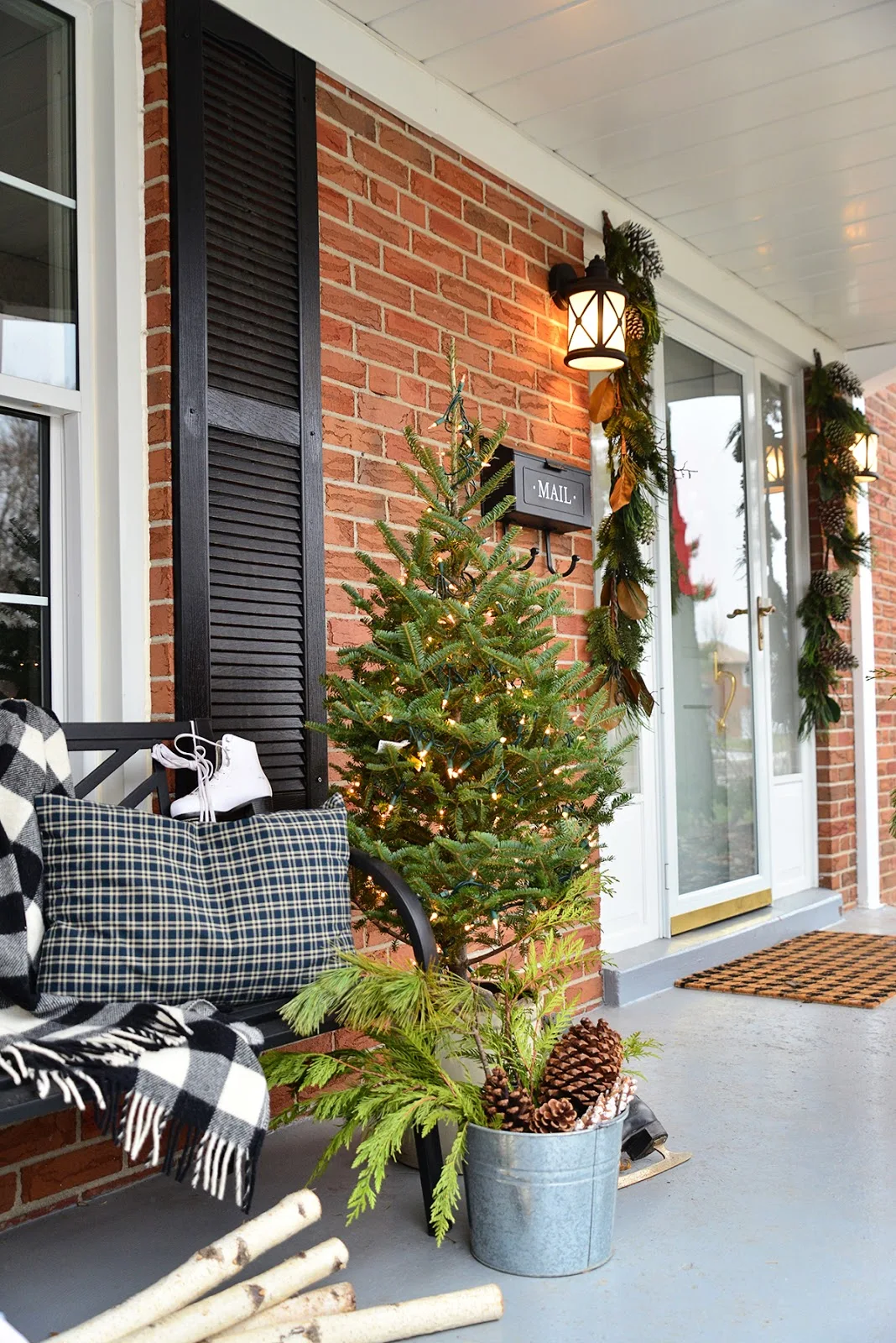 Christmas colonial house with wreaths in windows and decorated cozy Canadiana porch