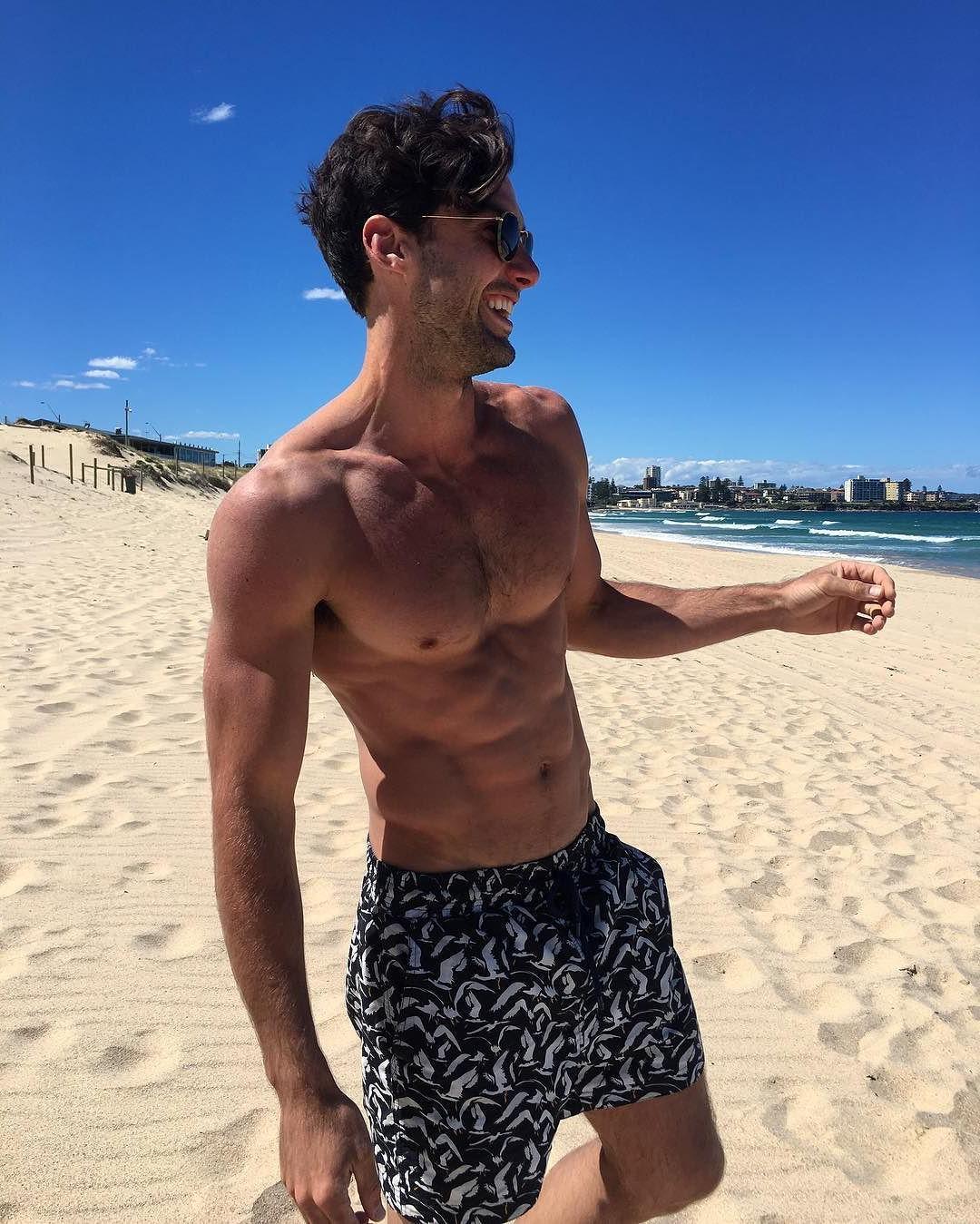 cute-hairy-barechest-gay-bottom-guy-smiling-beach-babe