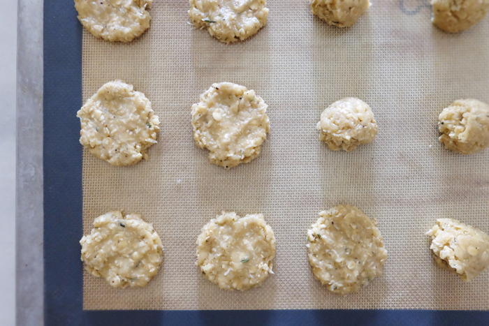 flattening cookie dough onto silicone baking mat