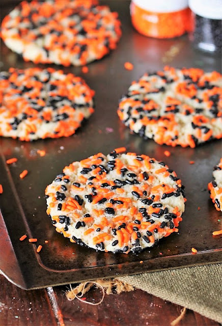 Black and Orange Halloween Sprinkle Sugar Cookies on Baking Sheet Image