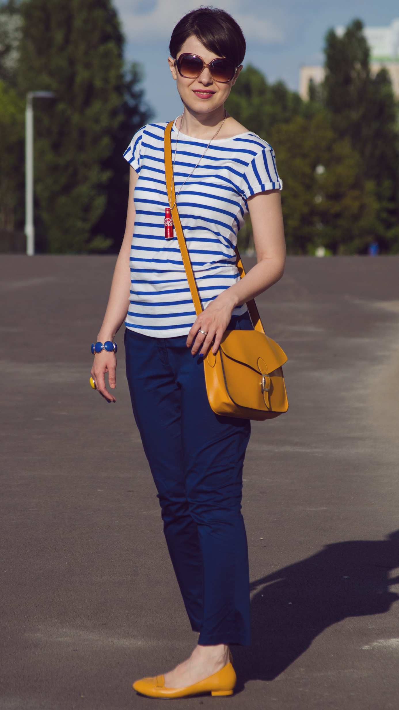 navy pants blue stripes t-shirt mustard bag flats jeans jacket coke little bottle