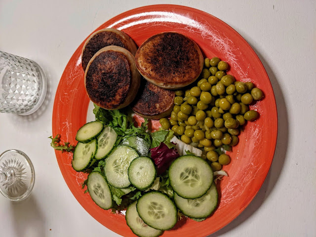 Plate of fish cakes, peas, and salad on our Oslo itinerary
