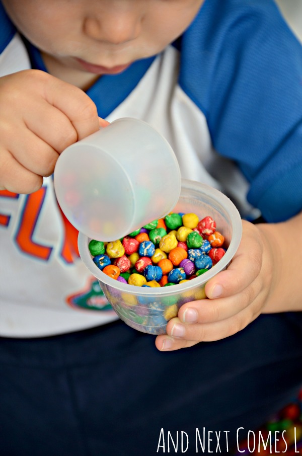 Playing with rainbow dyed dried chickpeas - a great sensory bin filler for toddlers and preschoolers from And Next Comes L