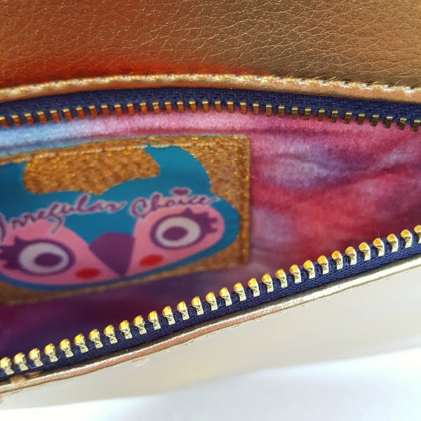 zip opening on back of clutch bag with velvet lining and irregular Choice branding
