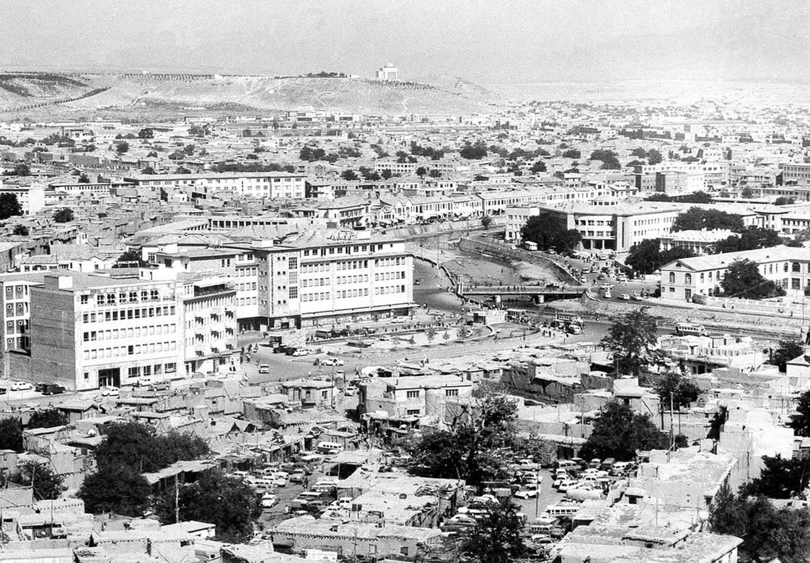 A panoramic view showing the old and new buildings in Kabul, in August of 1969. The Kabul River flows through the city, center right. In the background on the hilltop is the mausoleum of late King Mohammad Nadir Shah.