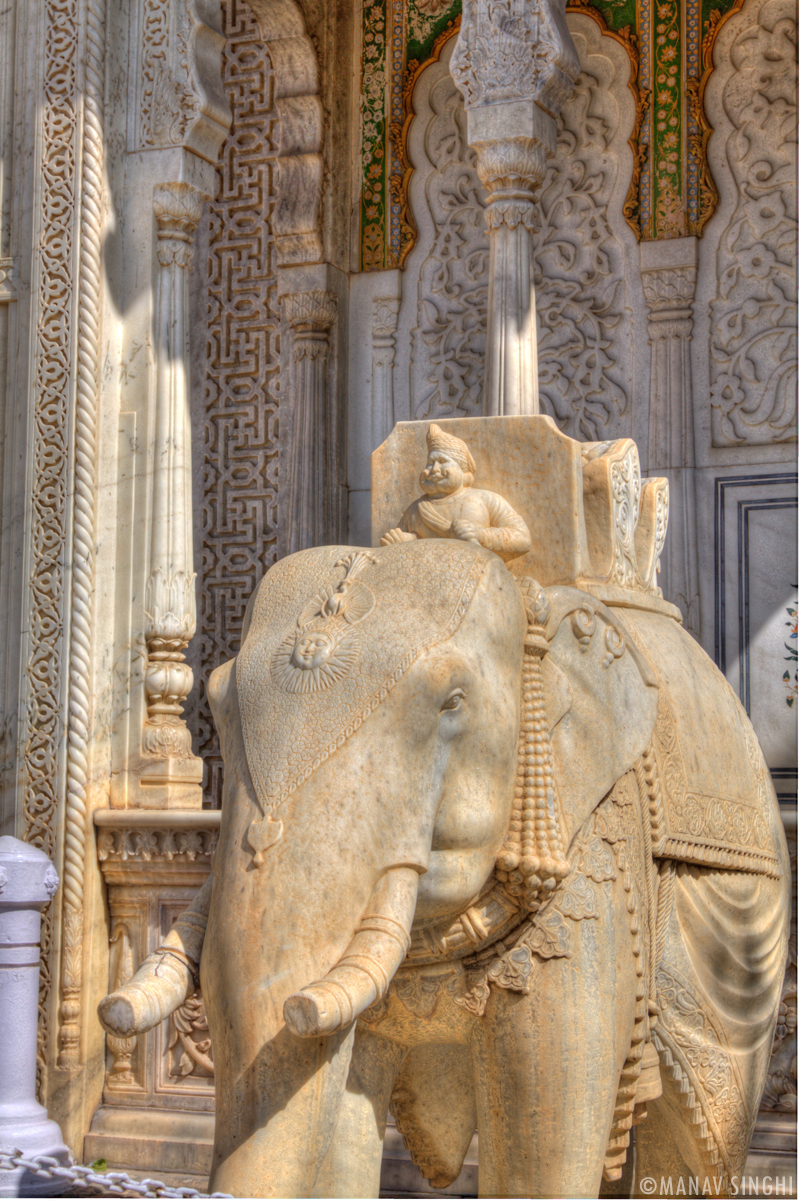 Beautiful Carvings and statue of Mahavat riding Elephant at the Gate at The City Palace, Jaipur.