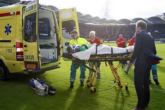 PSV goalkeeper Przemysław Tytoń is seen being taken away on an ambulance stretcher